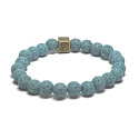 Láva světle modrá s královskou mantrou Óm, náramek elastický přírodní kámen, kulička 8 mm / 16 - 17 cm, zrozen ze čtyř živlů